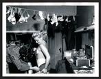 Weegee - A showgirl being helped into her costume in the