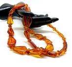 Lange vintage ketting met gesneden Baltisch barnsteen -, Verzamelen