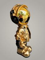 AmsterdamArts - Chanel gold astronaut statue