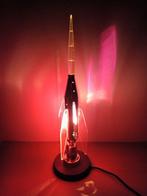 Space age stainless steel rocket lamp on wooden