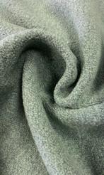 Zachte bouclé-stof met een warme, materiële structuur en een