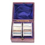 Boxed pair of sterling silver napkin rings with girdle