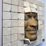 gregos - Bronze effect smile behind bricks
