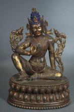 This is a bronze seated Guanyin statue with a serene and