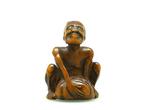 Netsuke dat een steenheffer voorstelt. - Hout - Japan - Edo