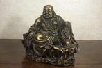 This is a large statue of Maitreya Buddha with a kind face
