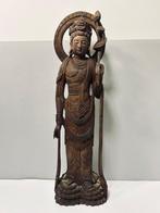 Large wooden sculptured Kannon statue with lotus flower on