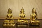 The three gilded Buddha statues—a bronze Guanyin Bodhisattva