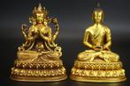 Two gilded bronze statues, one of the four-armed Guanyin and